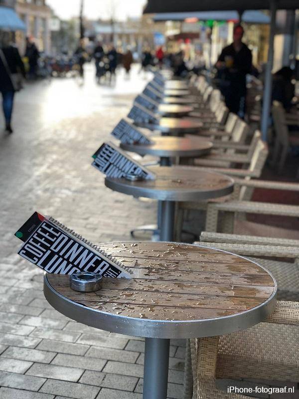 A terrace with menus on the tables