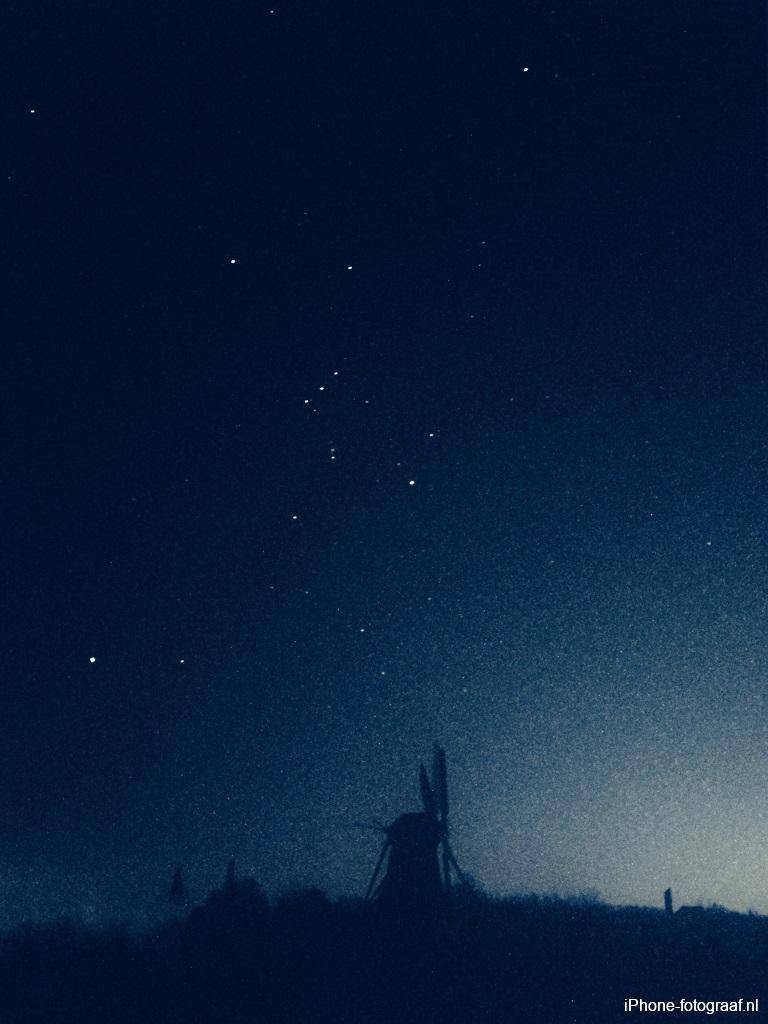 Molino de viento con un cielo nocturno